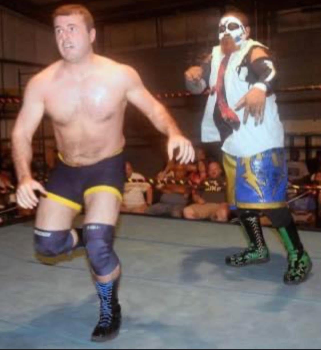 Duke Warfield in the ring facing a masked opponent
